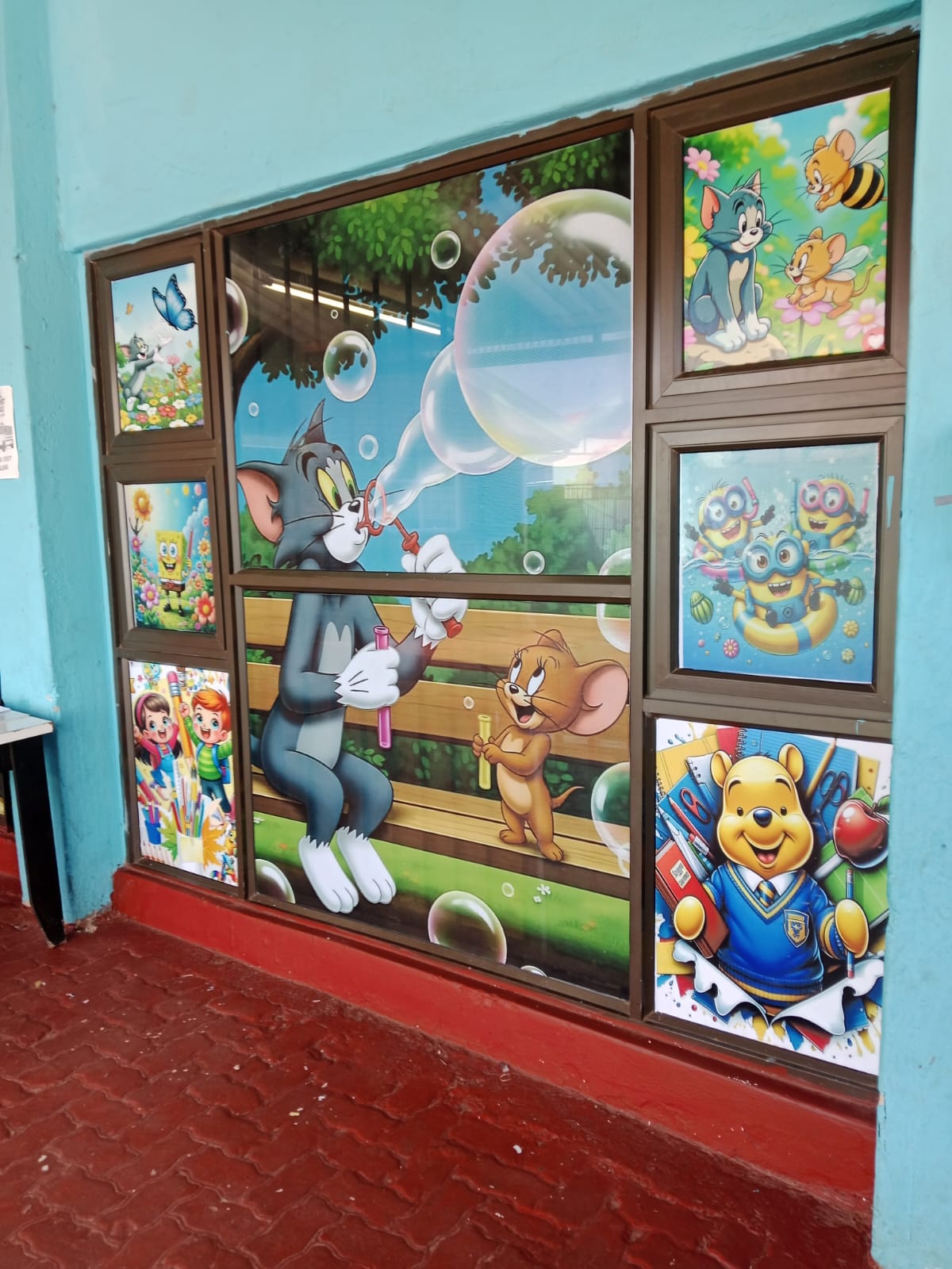 Colourful cartoon window murals at a school