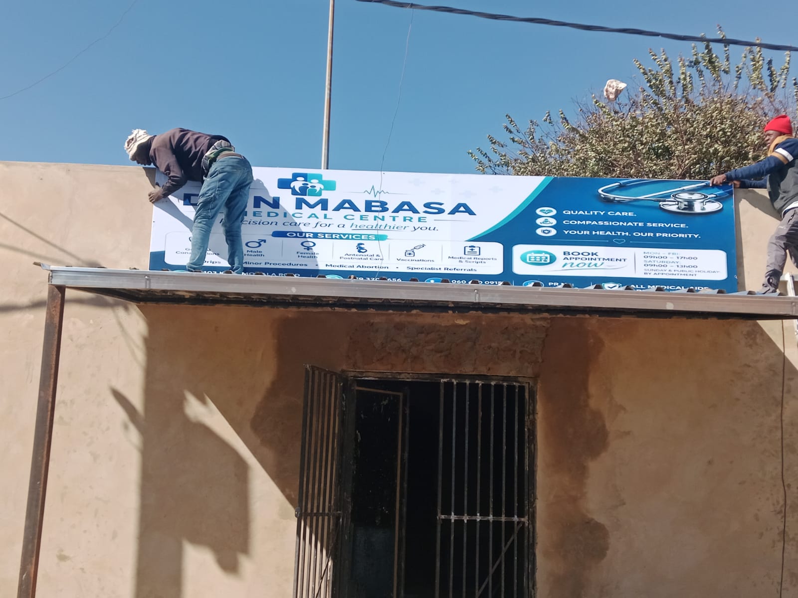 Storefront signboard being installed